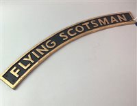 Lot 85 - A CAST IRON FLYING SCOTSMANS RAILWAY SIGN AND A TINPLATE MODEL BIPLANE