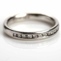 Lot 171 - DIAMOND HALF ETERNITY RING channel set with...