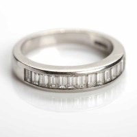 Lot 174 - DIAMOND HALF ETERNITY RING channel set with...