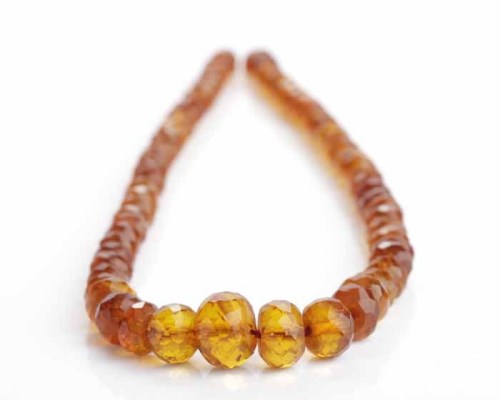 Lot 215 - GRADUATED AMBER BEAD NECKLACE with faceted...