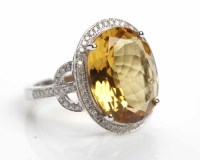 Lot 256 - BERYL AND DIAMOND RING set with a large oval...