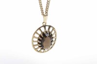 Lot 298 - GOLD SMOKY QUARTZ PENDANT of oval form and set...
