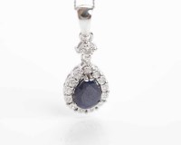 Lot 311 - SAPPHIRE AND DIAMOND PENDANT the central pear...