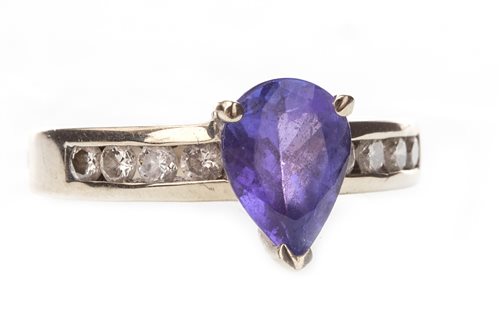 Lot 218 - A PEAR SHAPED PURPLE GEM AND DIAMOND RING