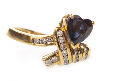 Lot 220 - A HEART SHAPED BLUE GEM AND DIAMOND RING