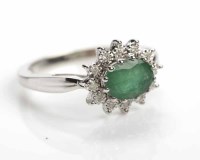 Lot 323 - EMERALD AND DIAMOND CLUSTER RING set with an...