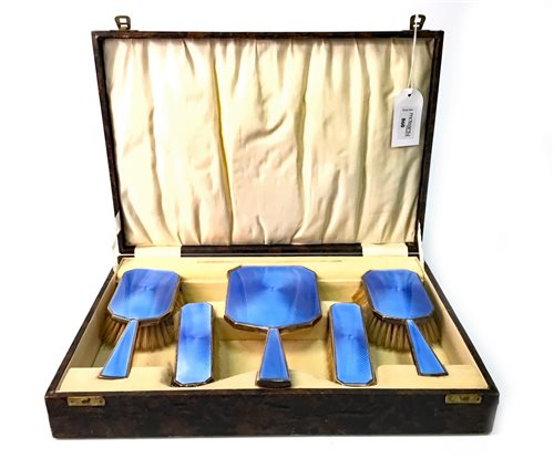 Lot 860 - A GEORGE V SILVER AND BLUE GUILLOCHE ENAMEL VANITY SET