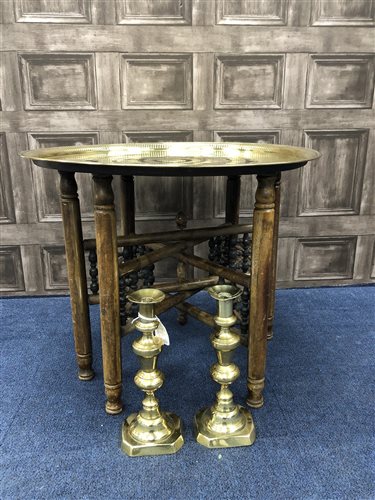 Lot 74 - A FOLDING TABLE WITH BRASS TOP AND PAIR OF BRASS CANDLESTICKS