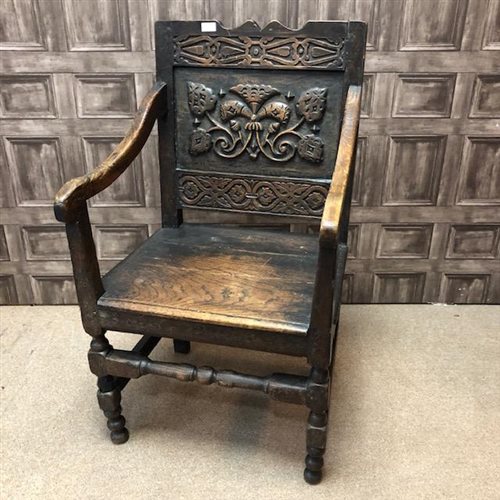 Lot 65 - A CARVED OAK ARM CHAIR