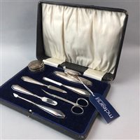 Lot 116 - A SILVER MOUNTED FRAME AND TWO SILVER MOUNTED MANICURE SETS