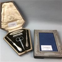 Lot 116 - A SILVER MOUNTED FRAME AND TWO SILVER MOUNTED MANICURE SETS