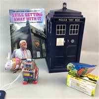 Lot 251 - A TOY MODEL OF THE TARDIS, THREE CHINESE TIN PLATE CLOCKWORK TOYS AND A RELATED BOOK