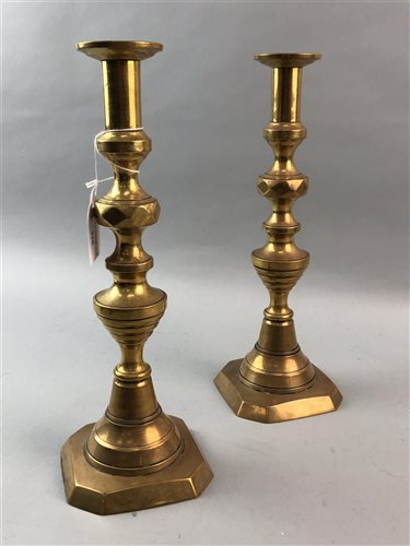 Lot 326 - A LOT OF TWO PAIRS OF BRASS CANDLESTICKS AND ANOTHER PAIR