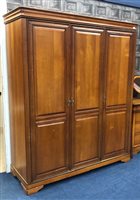 Lot 474 - A STAINED WOOD THREE DOOR WARDROBE