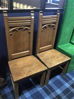 Lot 390 - Pair of oak church chairs with high backs and wide seats