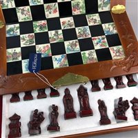 Lot 130 - A FOLDING PORTABLE CHESS BOARD AND CHESS PIECES