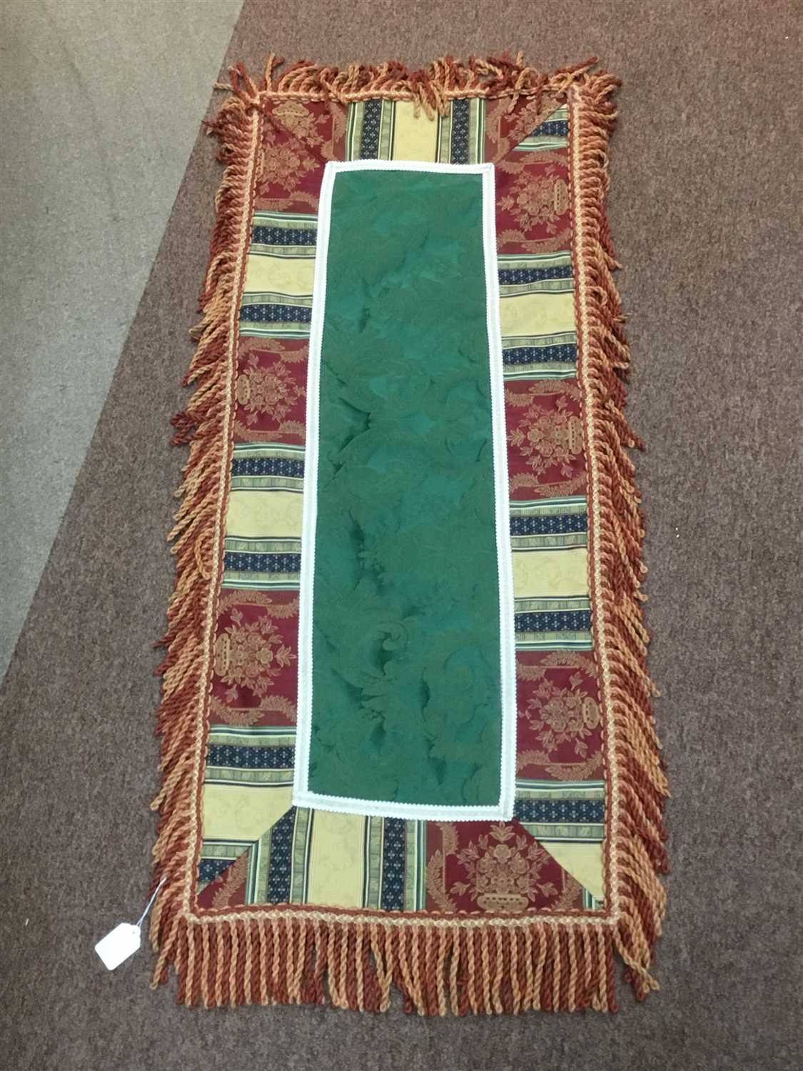 Lot 141 - AN EMBROIDERED AND FRINGED TABLE RUNNER