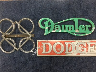 Lot 86 - PERKINS LOGO 'SQUARE DEAL ALL ROUND' BONNET BADGE,and a Daimler and Dodge badge (3)