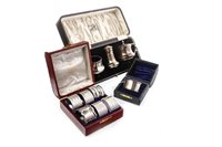 Lot 893 - A GEORGE V SILVER CRUET SET AND EIGHT SILVER NAPKIN RINGS