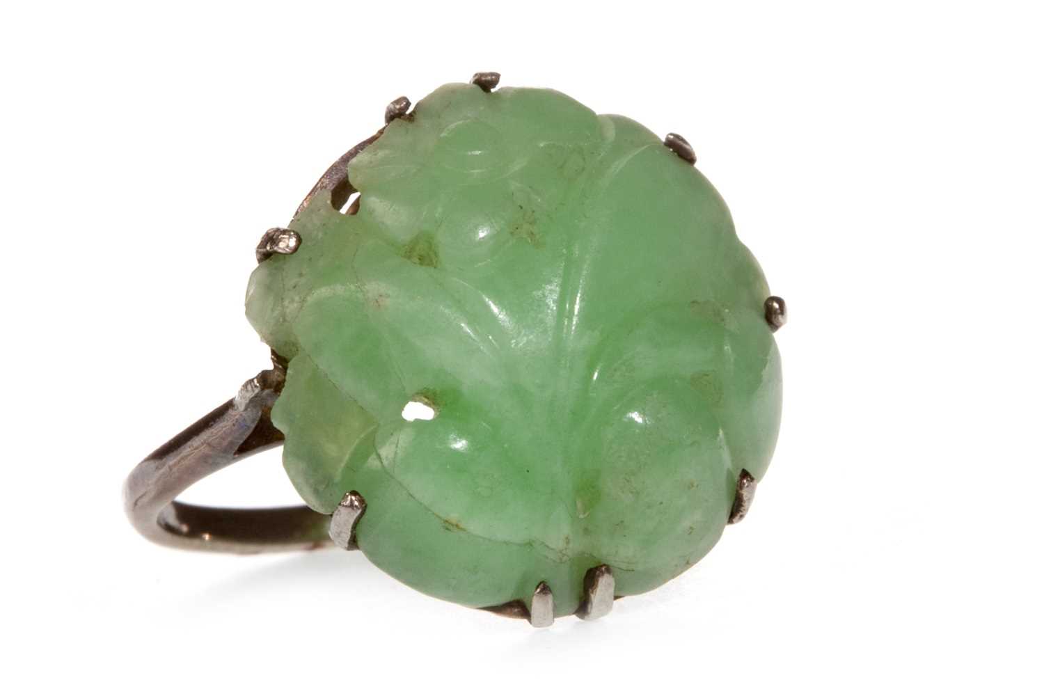 Lot 6 - A CARVED GREEN HARDSTONE RING