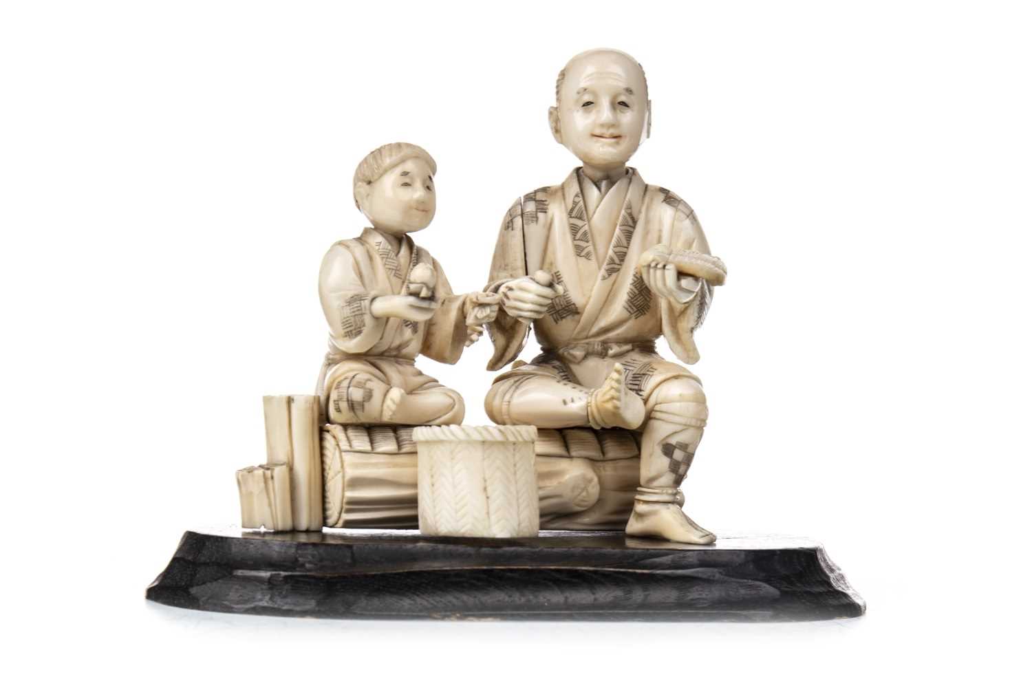 Lot 1022 - A JAPANESE CARVED IVORY FIGURE GROUP