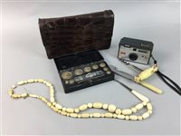 Lot 312 - A LADY'S LEATHER CLUTCH, CAMERA AND A CASED SET OF WEIGHTS