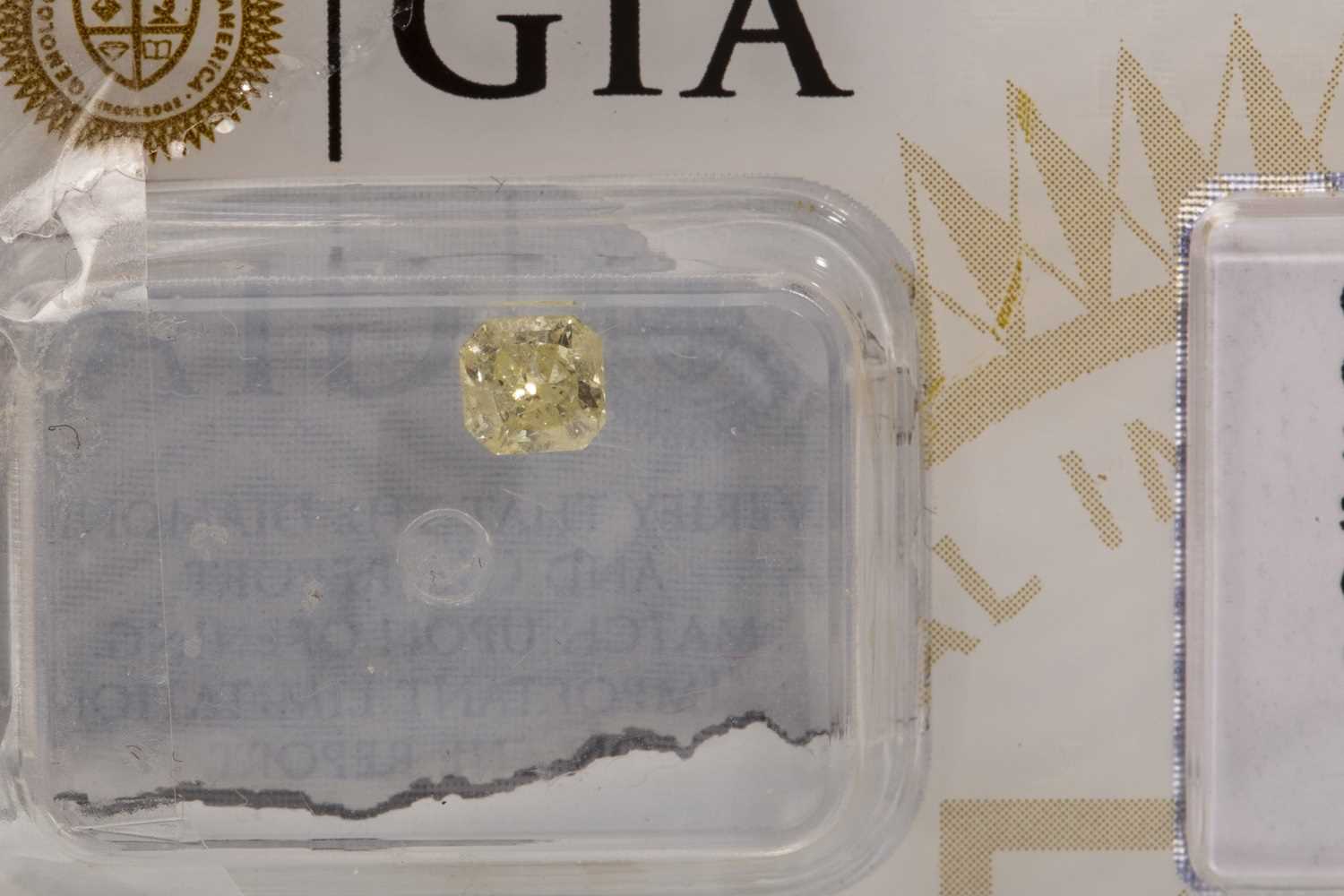 Lot 73 - A GIA CERTIFICATED UNMOUNTED YELLOW DIAMOND