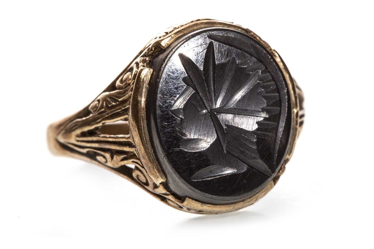 Lot 133 - A CARVED HAEMATITE SET RING
