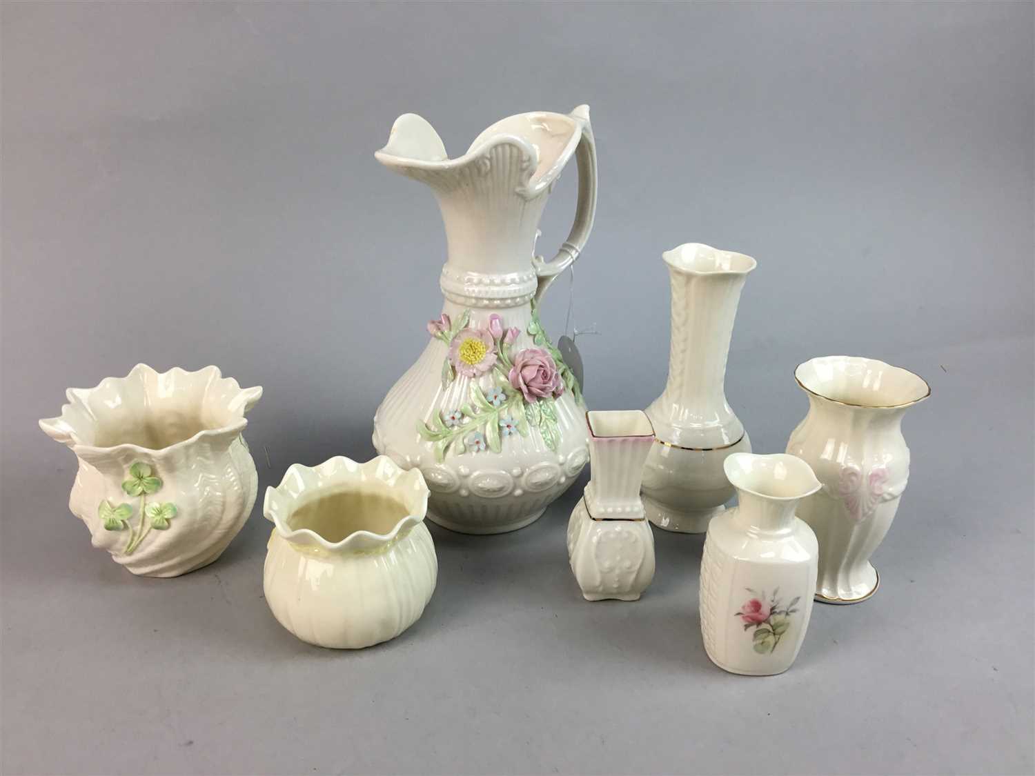 Lot 586 - A BELLEEK FLOWER ENCRUSTED EWER AND FIVE BELLEEK VASES AND ANOTHER VASE