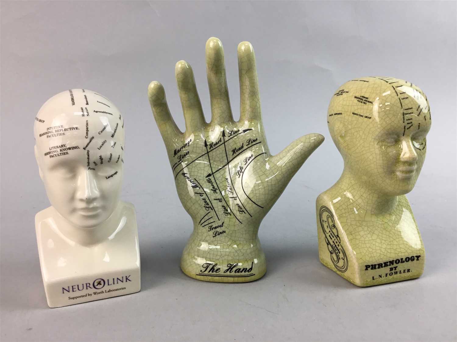 Lot 400 - A PALMISTRY HAND AND TWO CERAMIC PHRENOLOGY HEADS