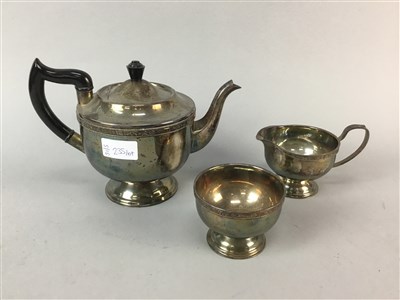 Lot 235 - A GLASS DECANTER AND A THREE PIECE PLATED TEA SERVICE