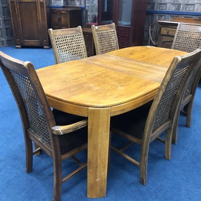 Lot 221 - A MODERN STAINED WOOD DINING TABLE AND SIX CANE BACK CHAIRS