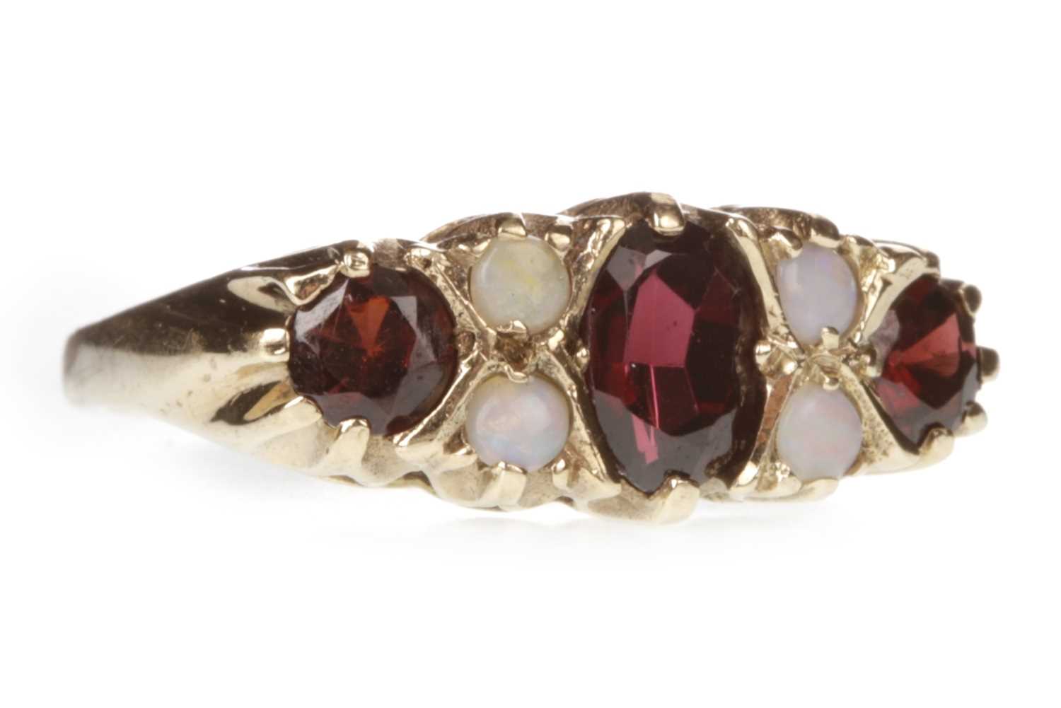 Lot 139 - A RED GEM SET AND OPAL RING