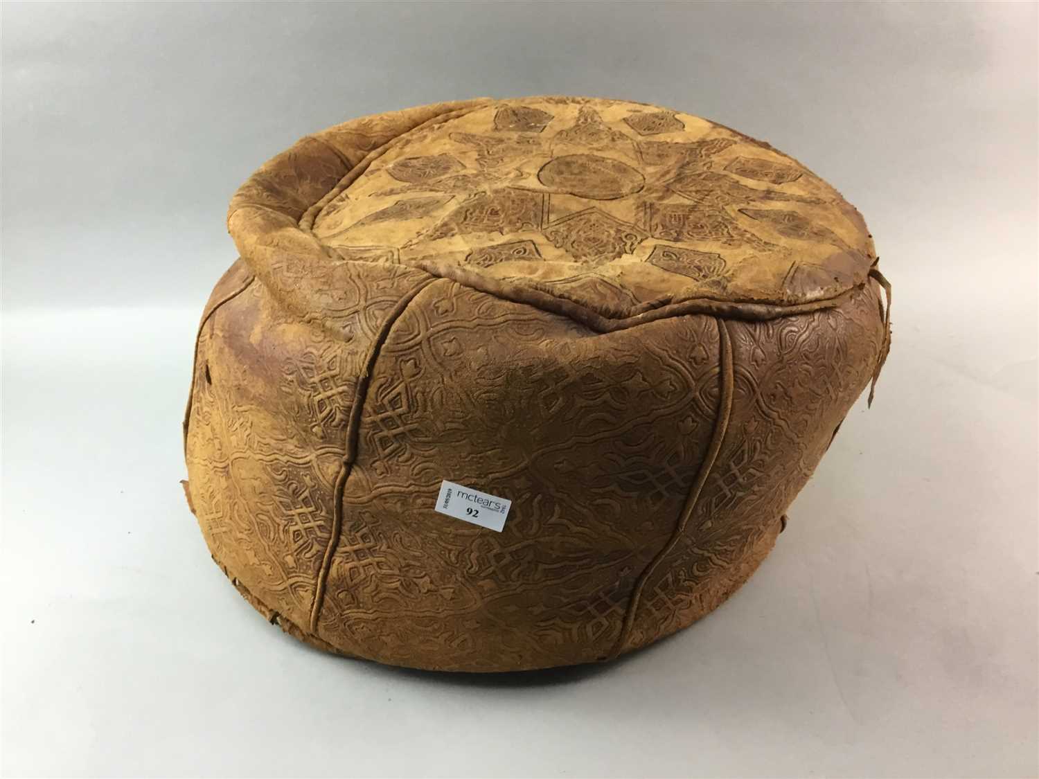 Lot 92 - A MOROCCAN LEATHER POUFFE