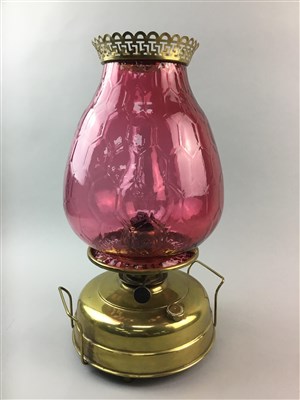 Lot 27 - A LARGE OIL LAMP WITH CRANBERRY GLASS SHADE