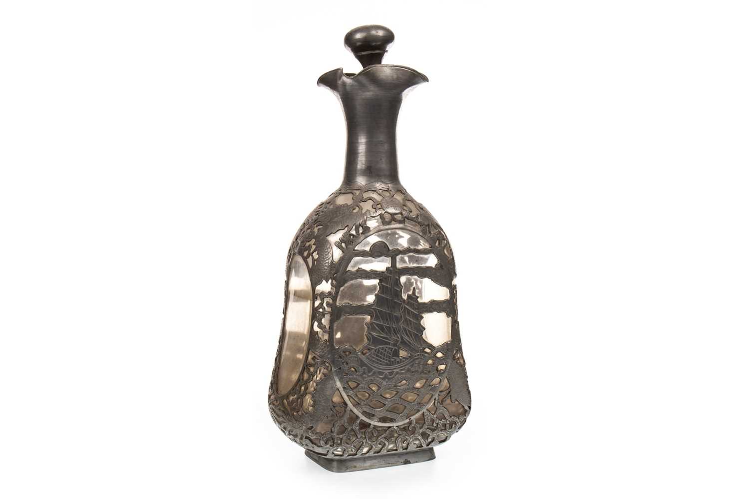 Lot 1108 - A 20TH CENTURY PEWTER OVERLAID GLASS DECANTER