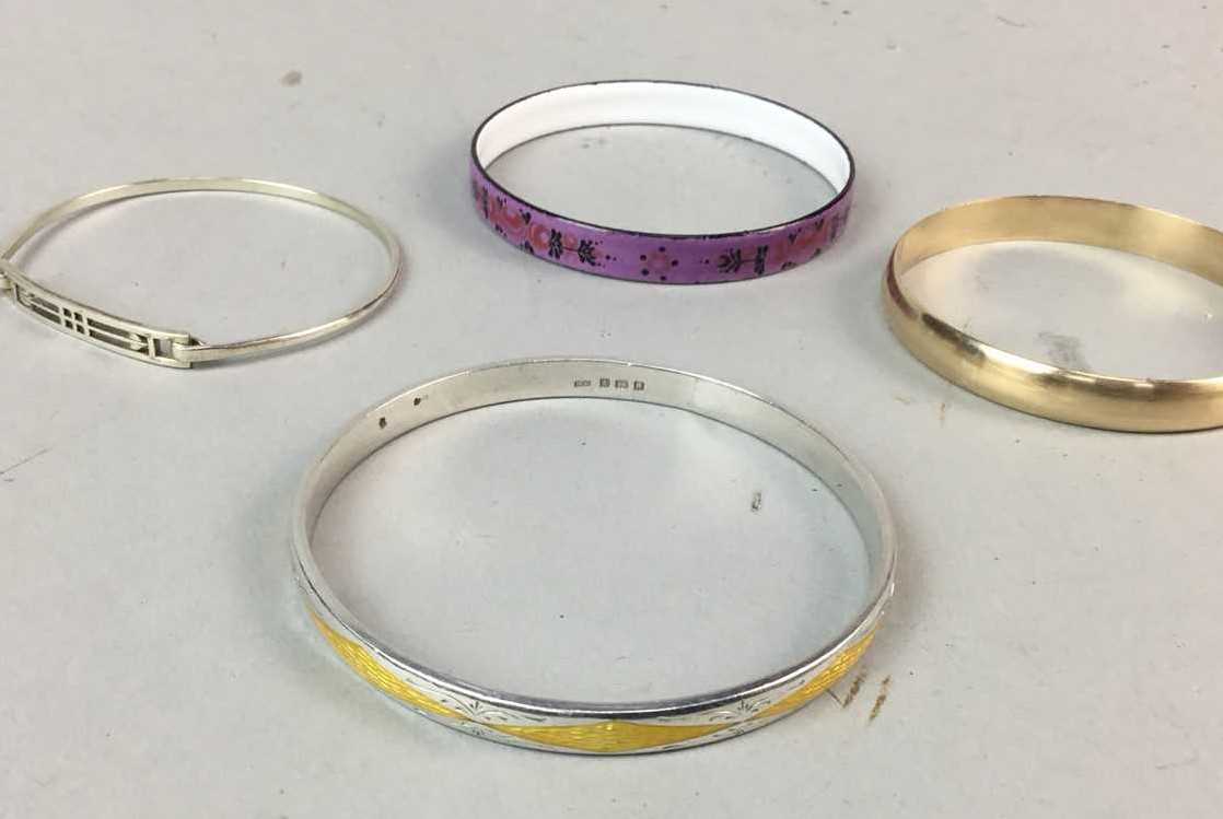 Lot 7 - A SILVER ENAMELLED BANGLE AND THREE OTHER BANGLES