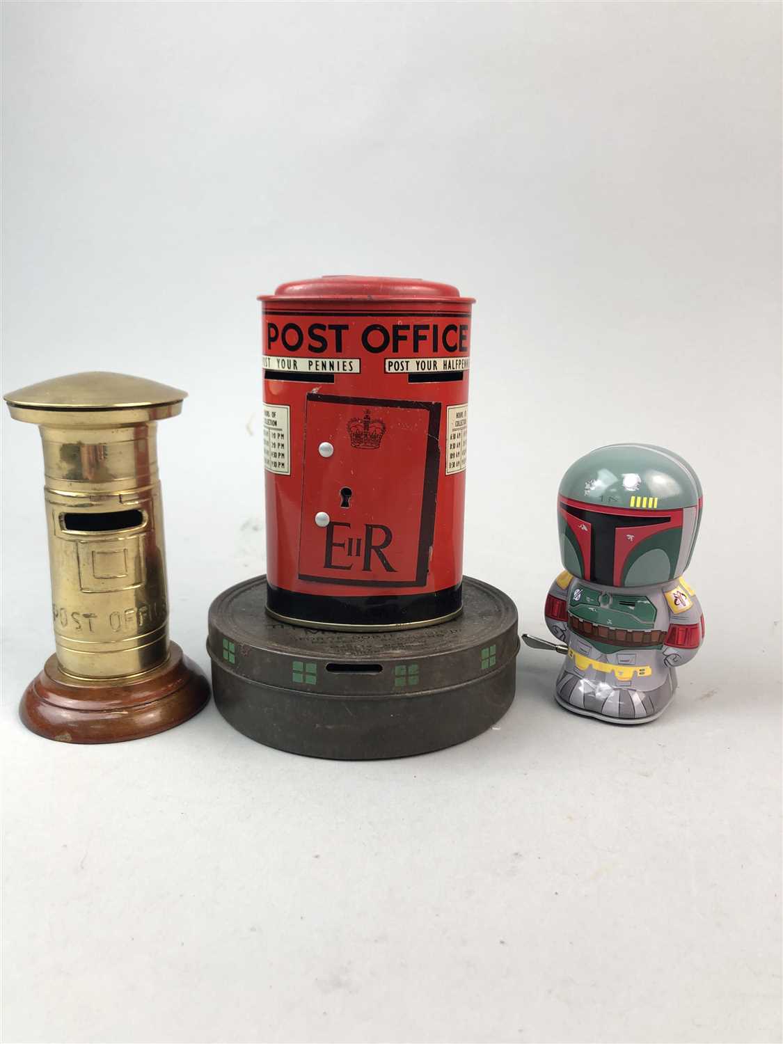 Lot 95 - A NOVELTY TIN MONEY BANK, A TIN WIND UP TOY AND TWO OTHER MONEY BOXES