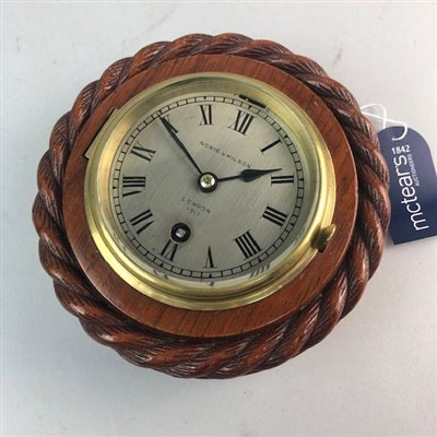 Lot 146 - A SMALL WALL TIMEPIECE BY NORIE & WILSON