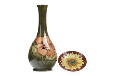Lot 1252 - A MOORCROFT 'HIBISCUS' VASE AND A 'SUNFLOWER' PLATE