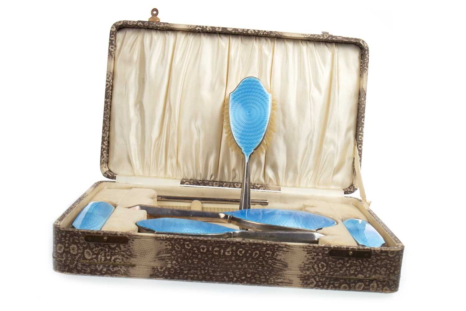 Lot 885 - A CASED GEORGE V SILVER AND BLUE GUILLOCHE ENAMEL VANITY SET