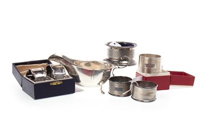 Lot 887 - A LOT OF FIVE SILVER NAPKIN RINGS AND AN IRISH SILVER SAUCE BOAT