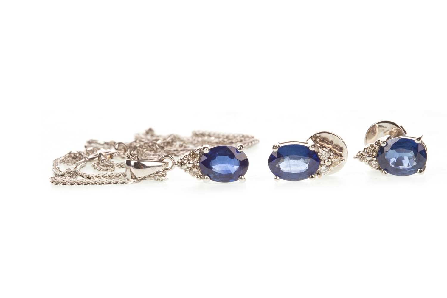 Lot 22 - A BLUE GEM AND DIAMOND PENDANT WITH MATCHING EARRINGS