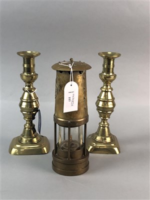 Lot 157 - A BRASS OIL LAMP AND A PAIR OF BRASS CANDLESTICKS