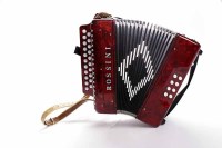 Lot 38 - MODERN ACCORDIAN BY ROSSINI in marbled red...