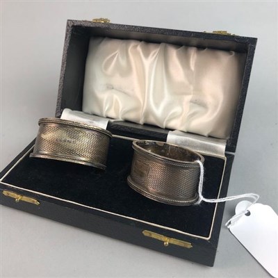 Lot 37 - FOUR SILVER NAPKIN RINGS AND A PLATED BRUSH SET