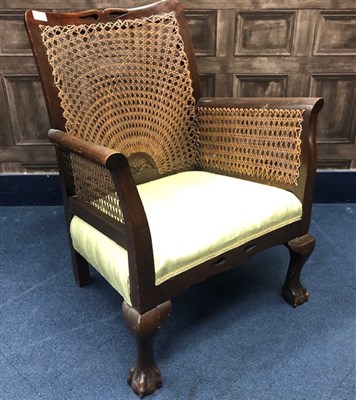 Lot 265 - A CANE BACK FIRESIDE ARMCHAIR
