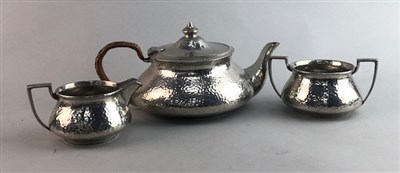 Lot 280 - A BEATEN PEWTER THREE PIECE TEA SERVICE