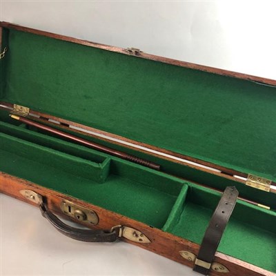 Lot 106 - A WOOD AND BRASS BOUND GUN CASE AND A LEATHER GUN CASE