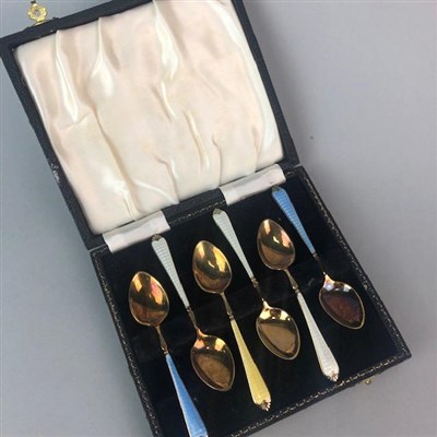 Lot 224 - A CASED SET OF SIX SILVER GILT AND ENAMEL COFFEE SPOONS